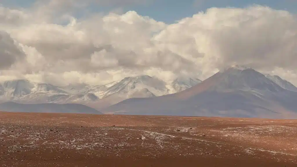 Atacama Salt Flats - a beautiful mountain landscape in the background of an arid, salty desert.