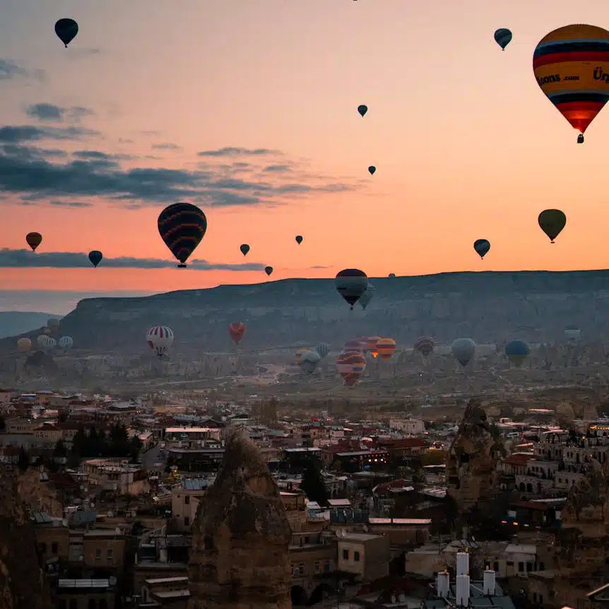 Hot air baloons over Cappadocia City in Turkey. Experience one of the most beautiful cities in the world from above.