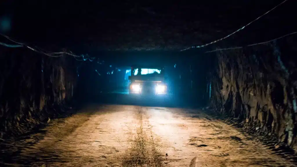 A vehicle driving through a wide tunnel of the Polkowice-Sieroszowice Salt Mine