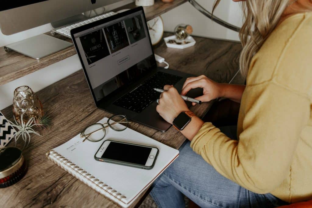 person in blue denim jeans work on macbook pro